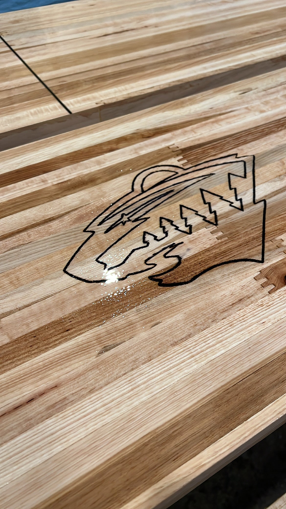 Shuffleboard surface engraving or decal embedding