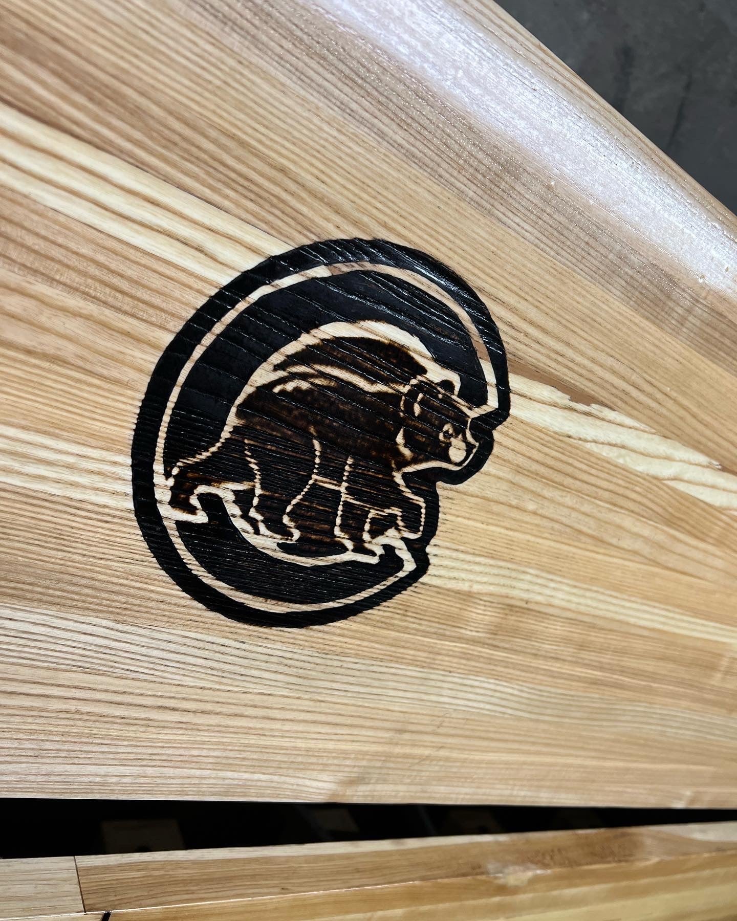 Shuffleboard surface engraving or decal embedding