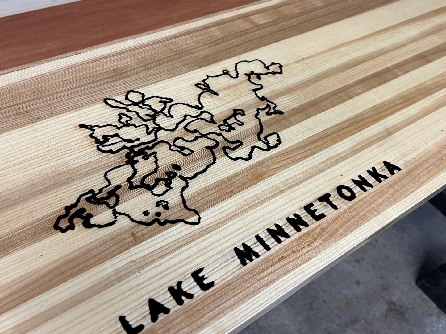 Shuffleboard surface engraving or decal embedding