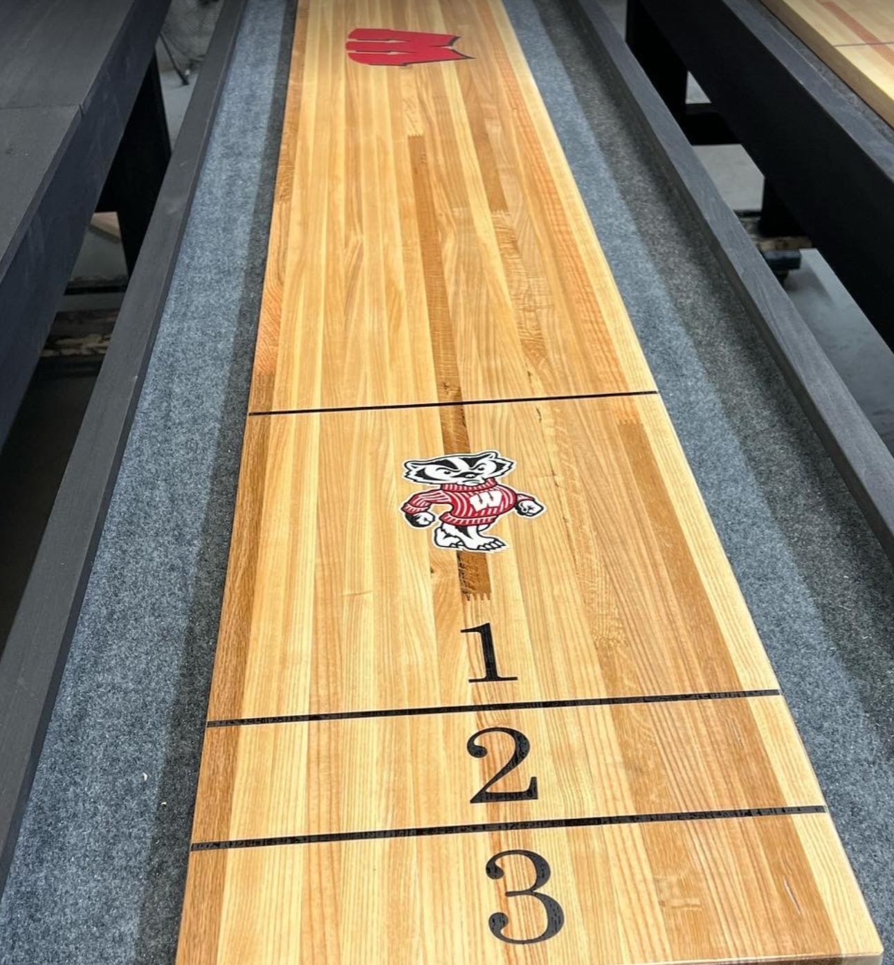 Shuffleboard surface engraving or decal embedding